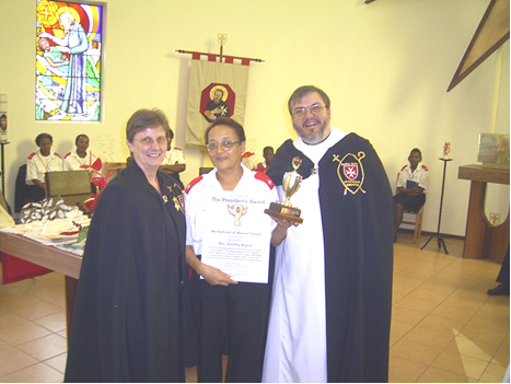 Vice-President Clare Kalkwarf, Dorothy Wynne with her certificate and trophy, and President Father Gérard at the 2003 presentation