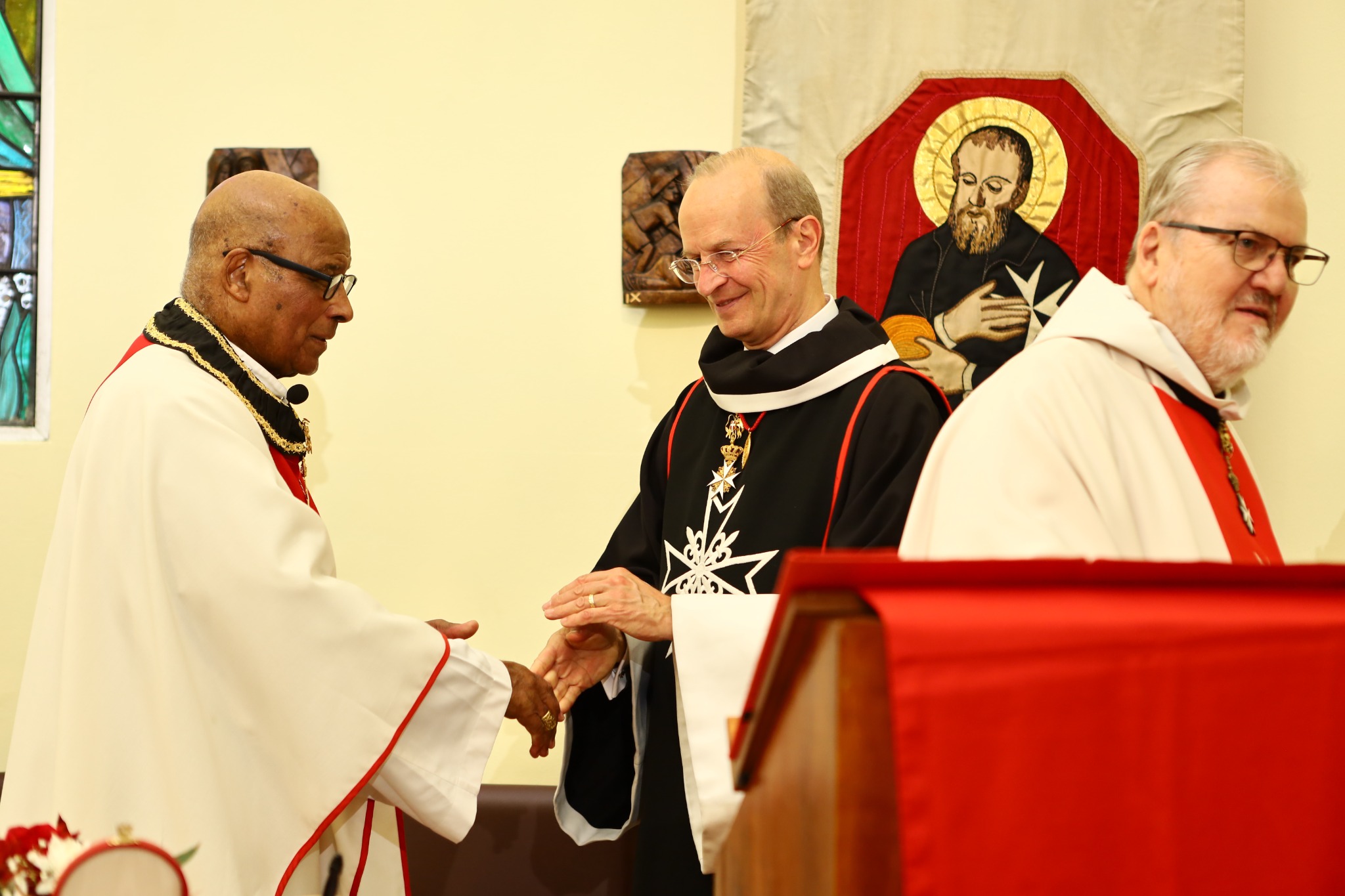 Major General Dr Josef D. Blotz exchanging the sign of peace with Cardinal Napier