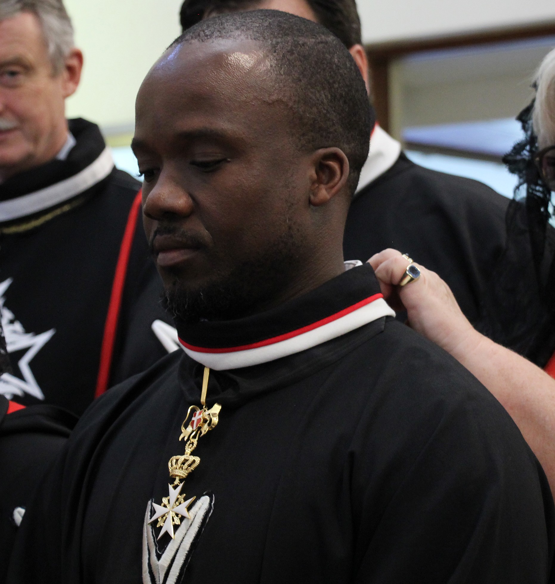 Dr Sikhumbuzo Khayelihle Nzimande receiving the robes of a Knight of Magistral Grace