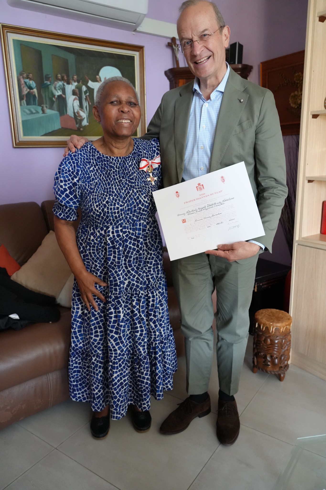 Nokuthula Marigold Thabethe wearing the Cross with Crown pro Merito Melitensi and holding its diploma at her home on 7 September 2026